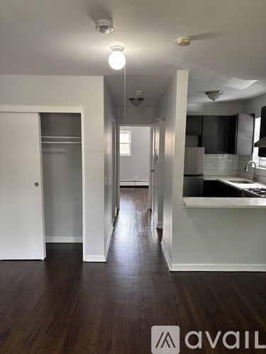 A long hallway with a kitchen area on the right.