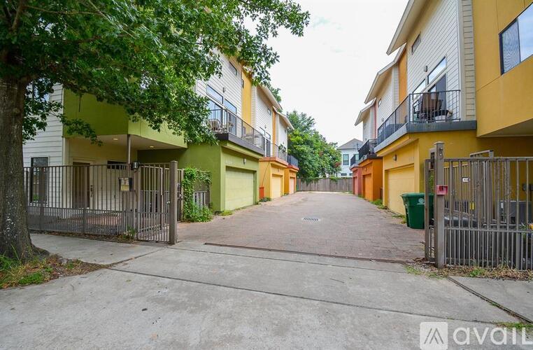 A street view of a residential area with apartment buildings on either side.