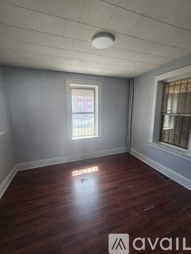 A room with wooden floors and a window.