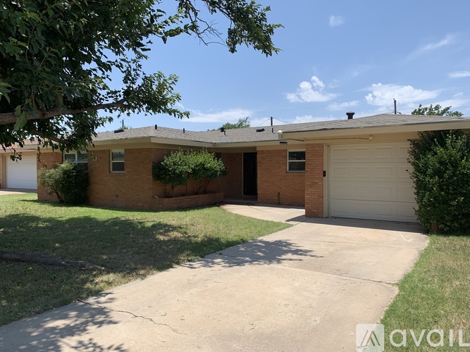 A house with a garage and a driveway is available for rent.