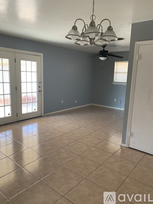 A room with a ceiling fan and a light fixture.