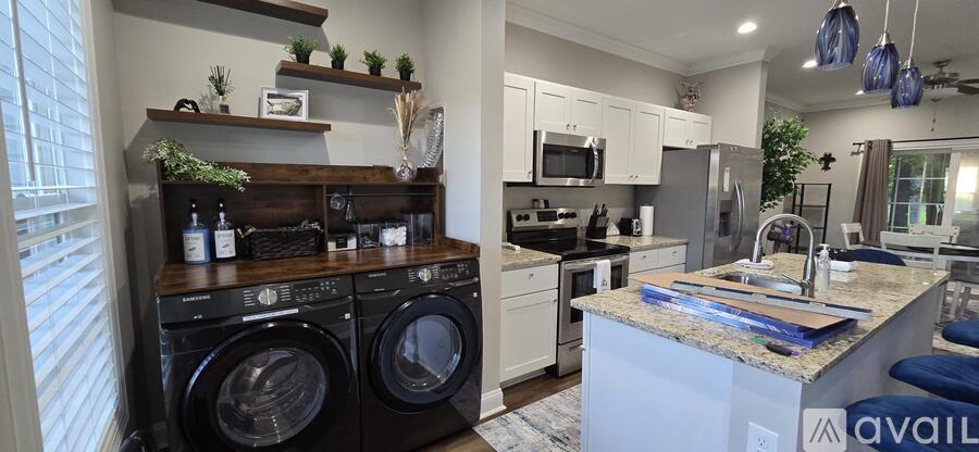 A kitchen with a washer and dryer built into the counter.