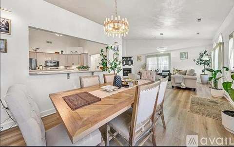 A modern kitchen with a dining table and chairs.