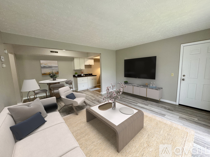 A living room with a grey couch, a coffee table, and a television.