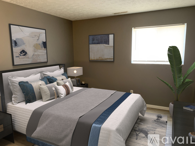A bedroom with a large bed and a plant.