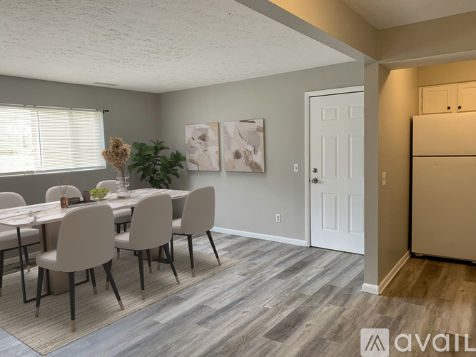 A dining room with a table and chairs.