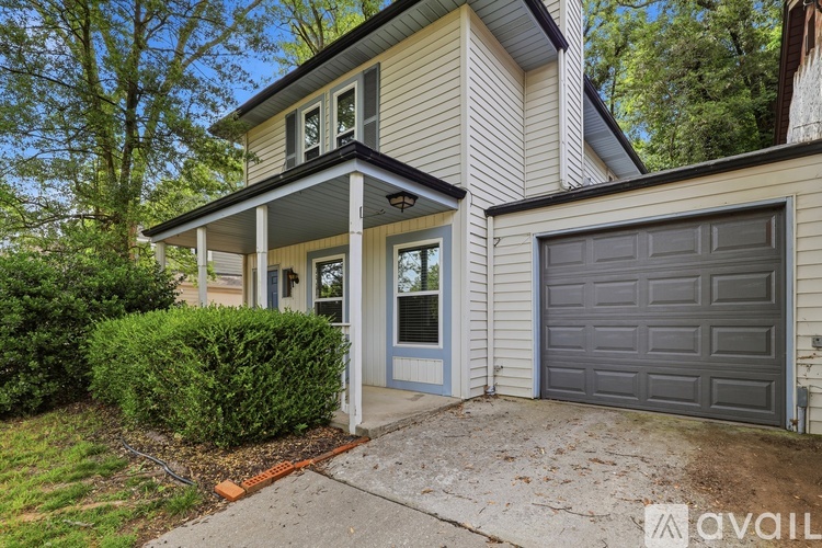 A house with a garage door and a porch.