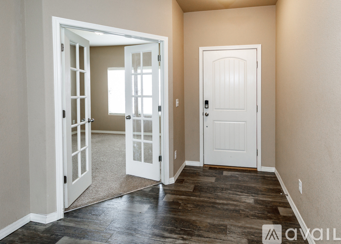 A room with a white door and a window.