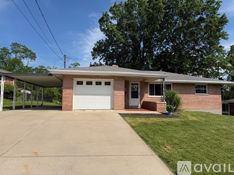 A house with a garage and a driveway in front.
