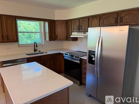 A kitchen with wooden cabinets and a white countertop.