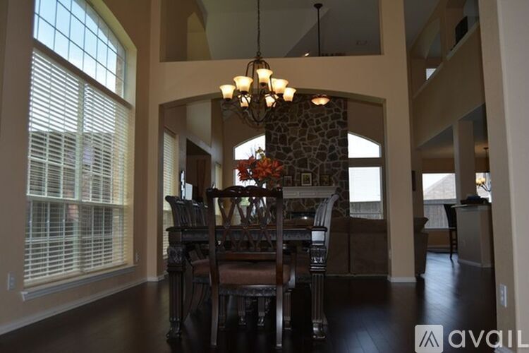 A dining room with a table set for four.