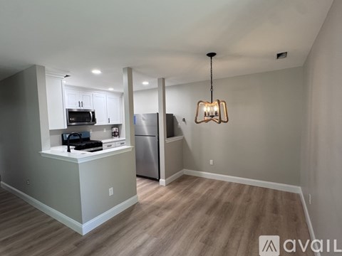 A kitchen with a refrigerator, microwave, and oven.