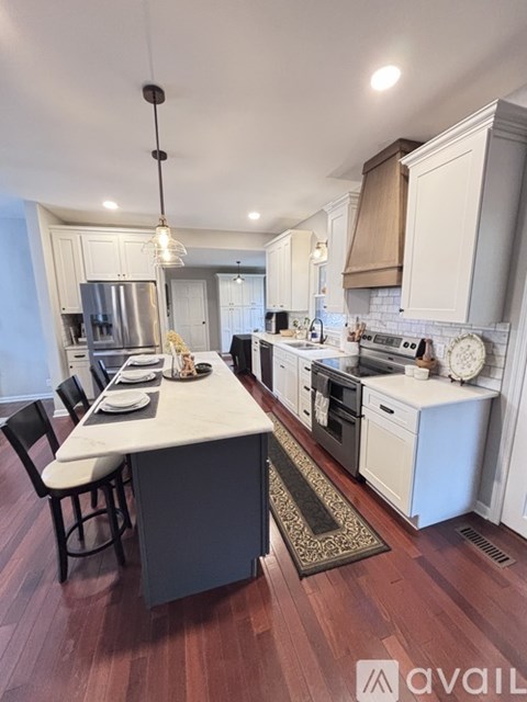 A kitchen with a table and chairs in the middle of the room.