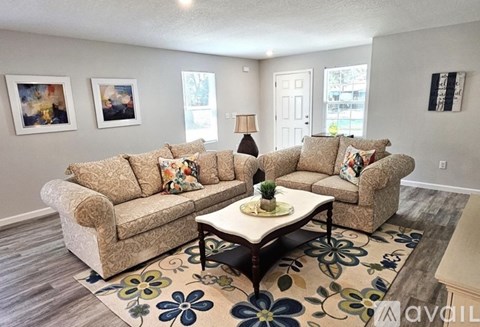 A living room with a large sectional sofa and a coffee table.