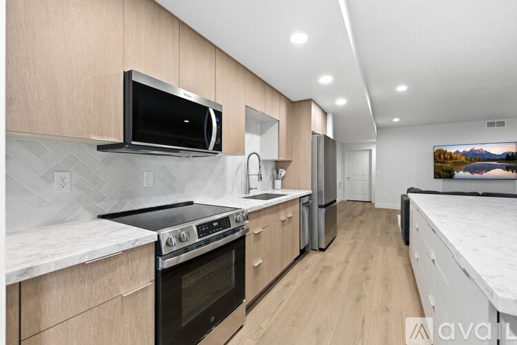 A modern kitchen with wooden cabinets and stainless steel appliances.
