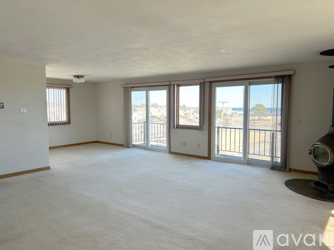 A spacious room with a view of the outside through large windows.