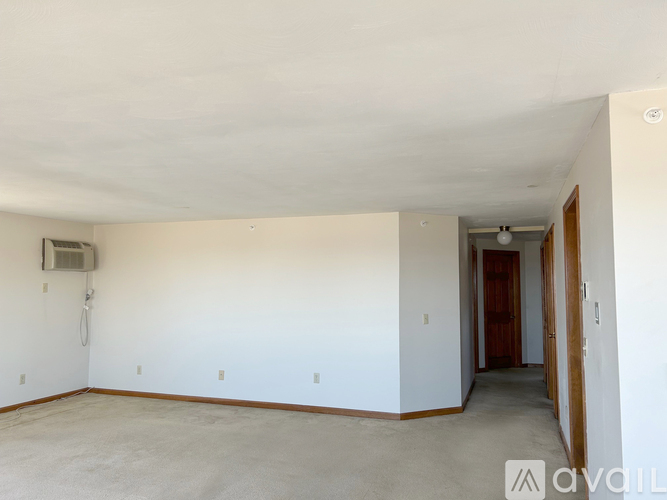 A large empty room with a door on the right side.