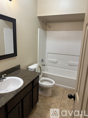 A bathroom with a sink, toilet and bathtub.