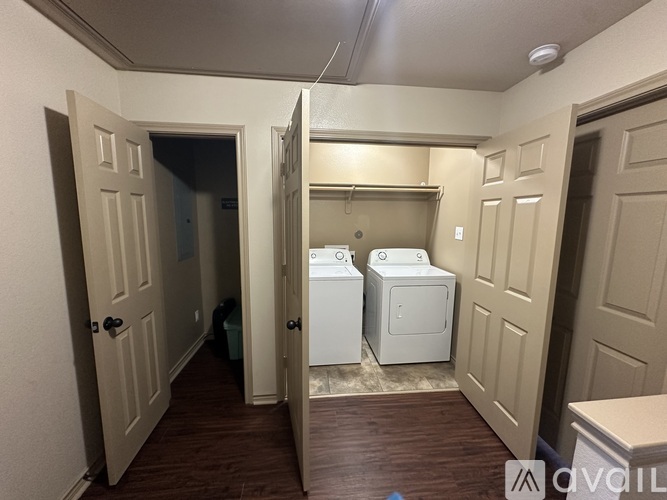 A room with a white fridge and a white dishwasher.