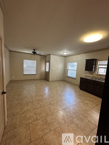 A room with tile flooring and a ceiling fan.