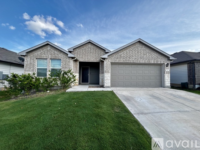 A house with a garage and a driveway is available for sale.