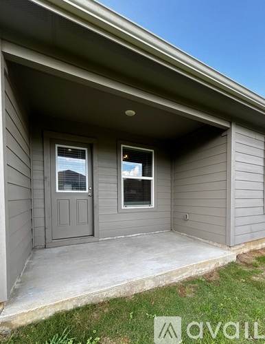 A house with a grey exterior and a grey door and window.