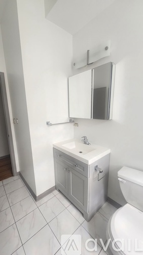 A white bathroom with a toilet and sink.