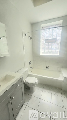 A bathroom with a toilet, sink, and bathtub.