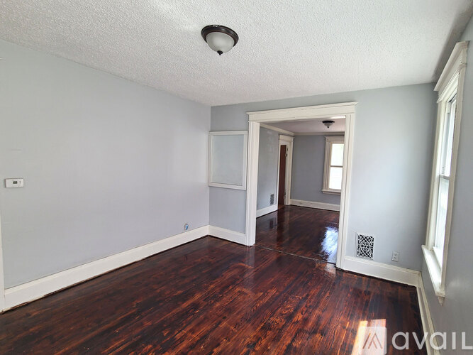 A room with wooden floors and white walls.
