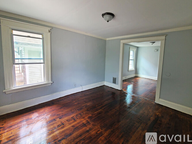A room with wooden floors and a window.