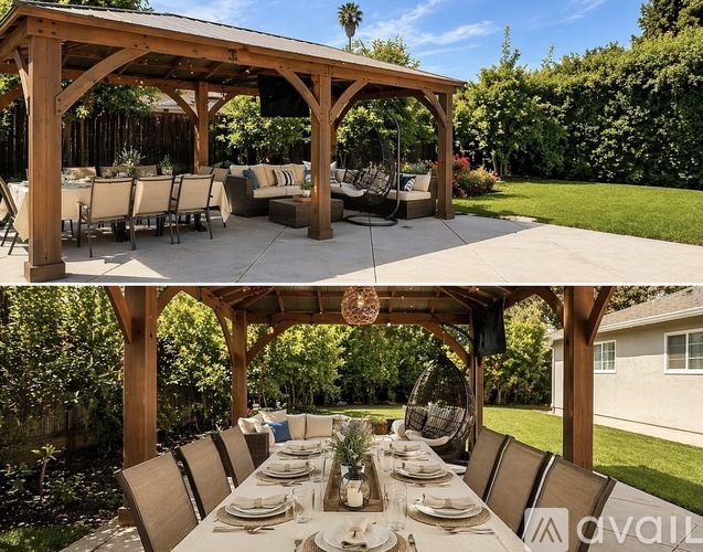 A wooden pergola with a table set for a meal underneath it.