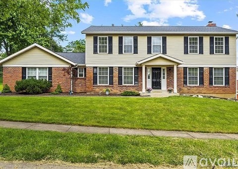 A two-story house with a brick facade and a front porch.