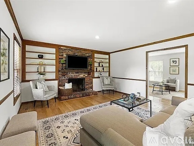A living room with a fireplace and a television.
