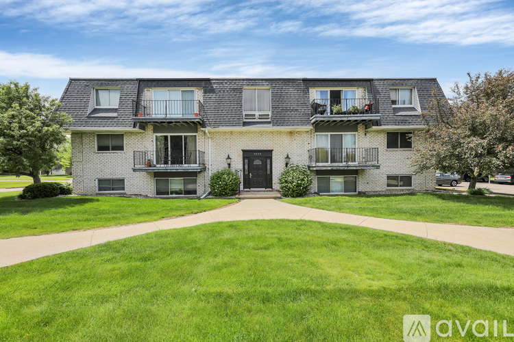 A large, well-maintained house with a front yard and a driveway.