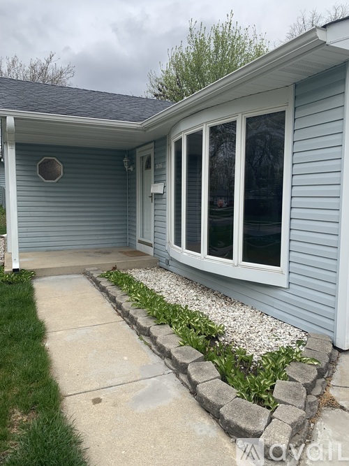 A house with a blue siding and a white door.