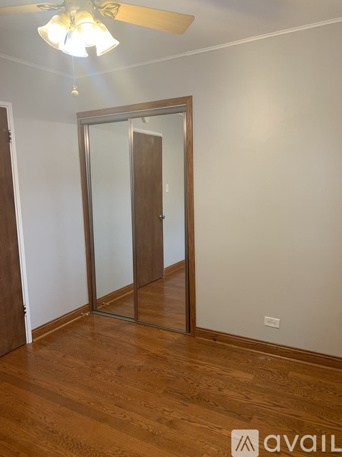 A room with a wooden floor and a glass door.