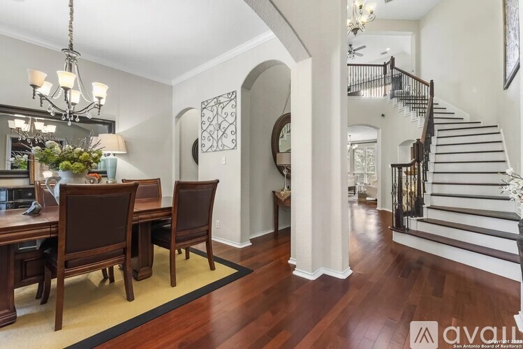 A dining room with a wooden table and chairs.