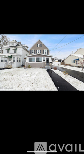 A house with a snow-covered front yard.