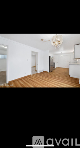 A room with wooden floors and white walls.