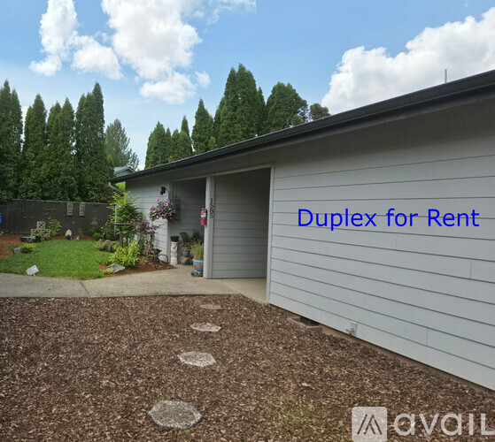 A house with a garage and a sign that says "Duplex for Rent".