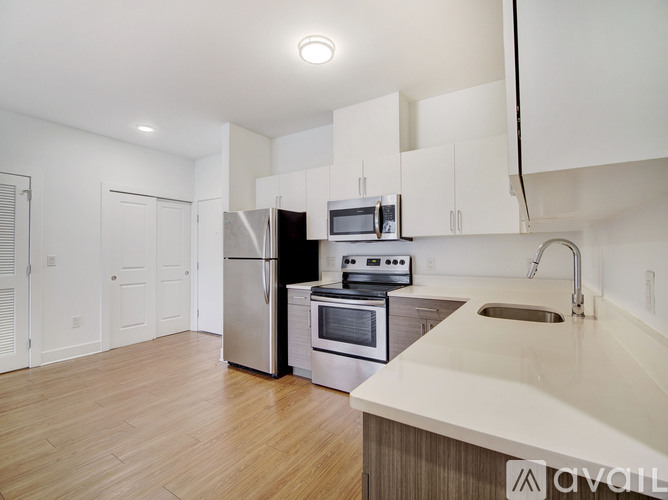A kitchen with white cabinets and stainless steel appliances.