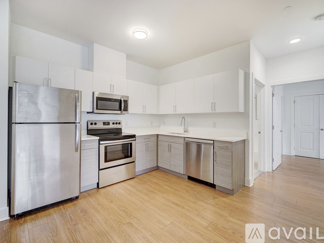 A kitchen with white cabinets and stainless steel appliances.