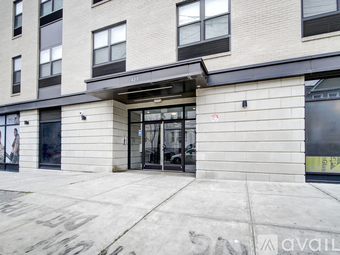 The entrance to a building with a glass door and a sign that says "available".