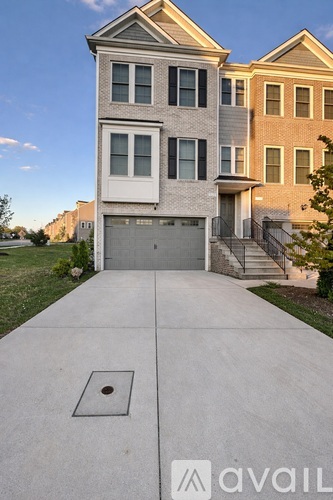 A two-story house with a garage is available for sale.