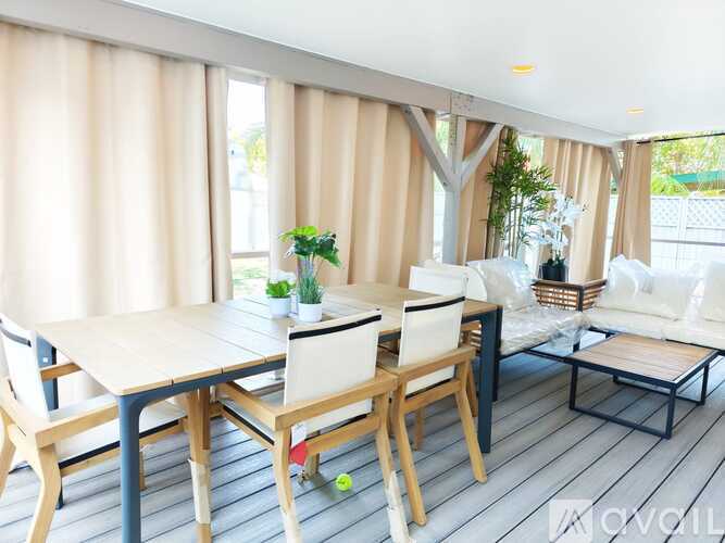 A dining room with a table and chairs.
