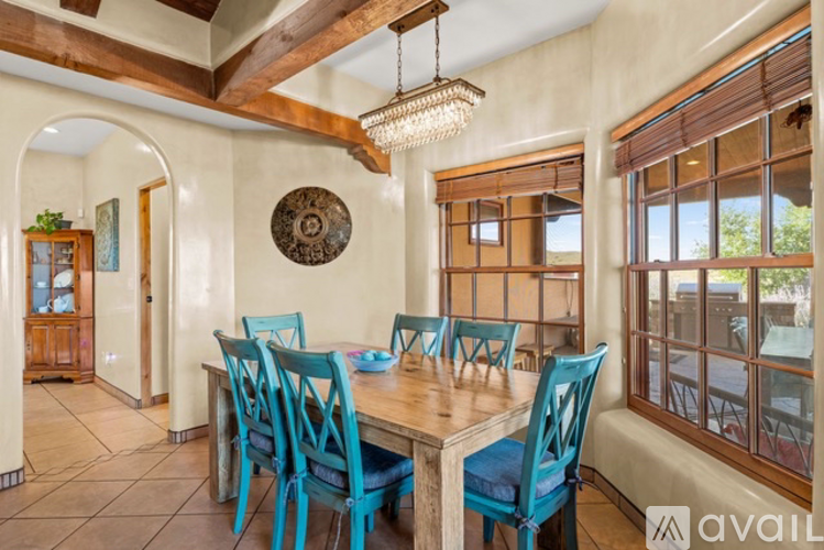A dining room with a wooden table and blue chairs.