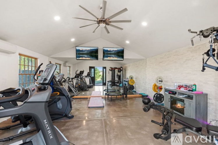 A well-equipped home gym with a variety of exercise equipment.