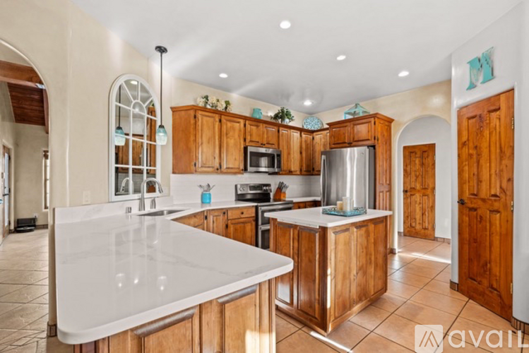 A kitchen with wooden cabinets and a white countertop.