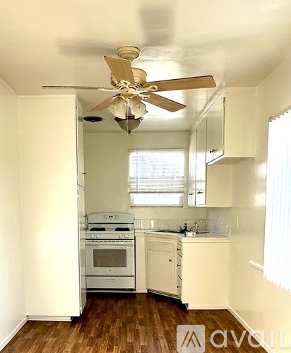 A kitchen with a white oven and a fan.