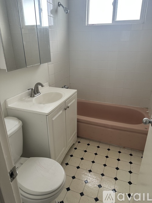 A bathroom with a toilet, sink, and bathtub.